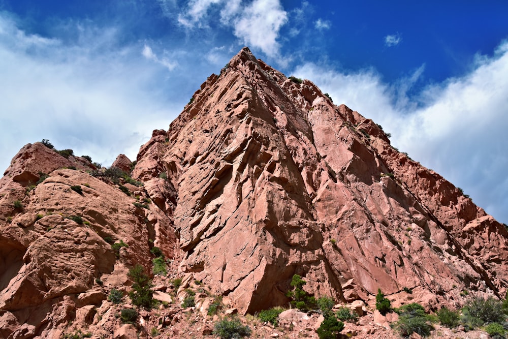 a very tall mountain with a sky in the background