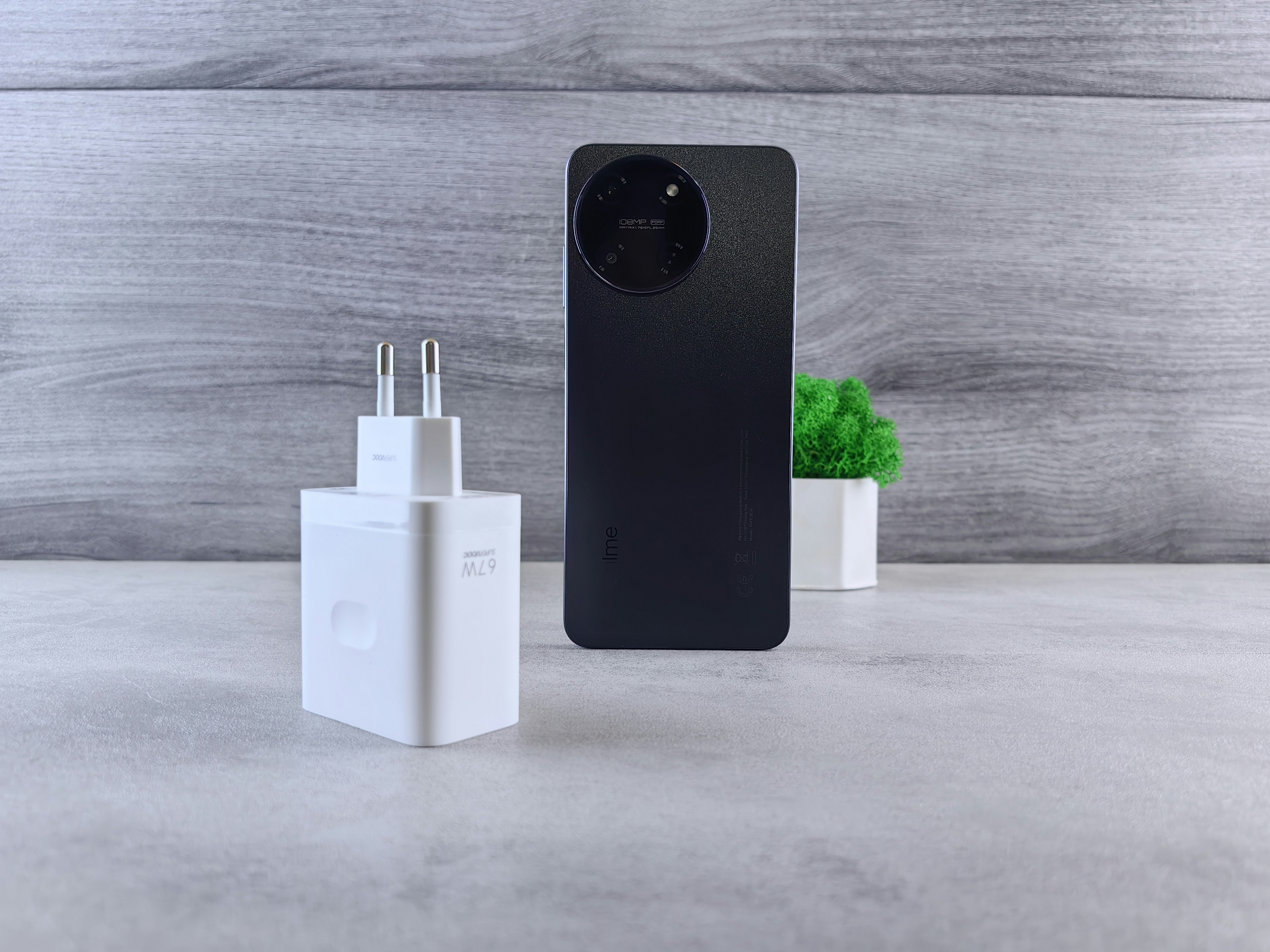 a black and white cell phone next to a charger