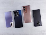 a group of four cell phones sitting next to each other