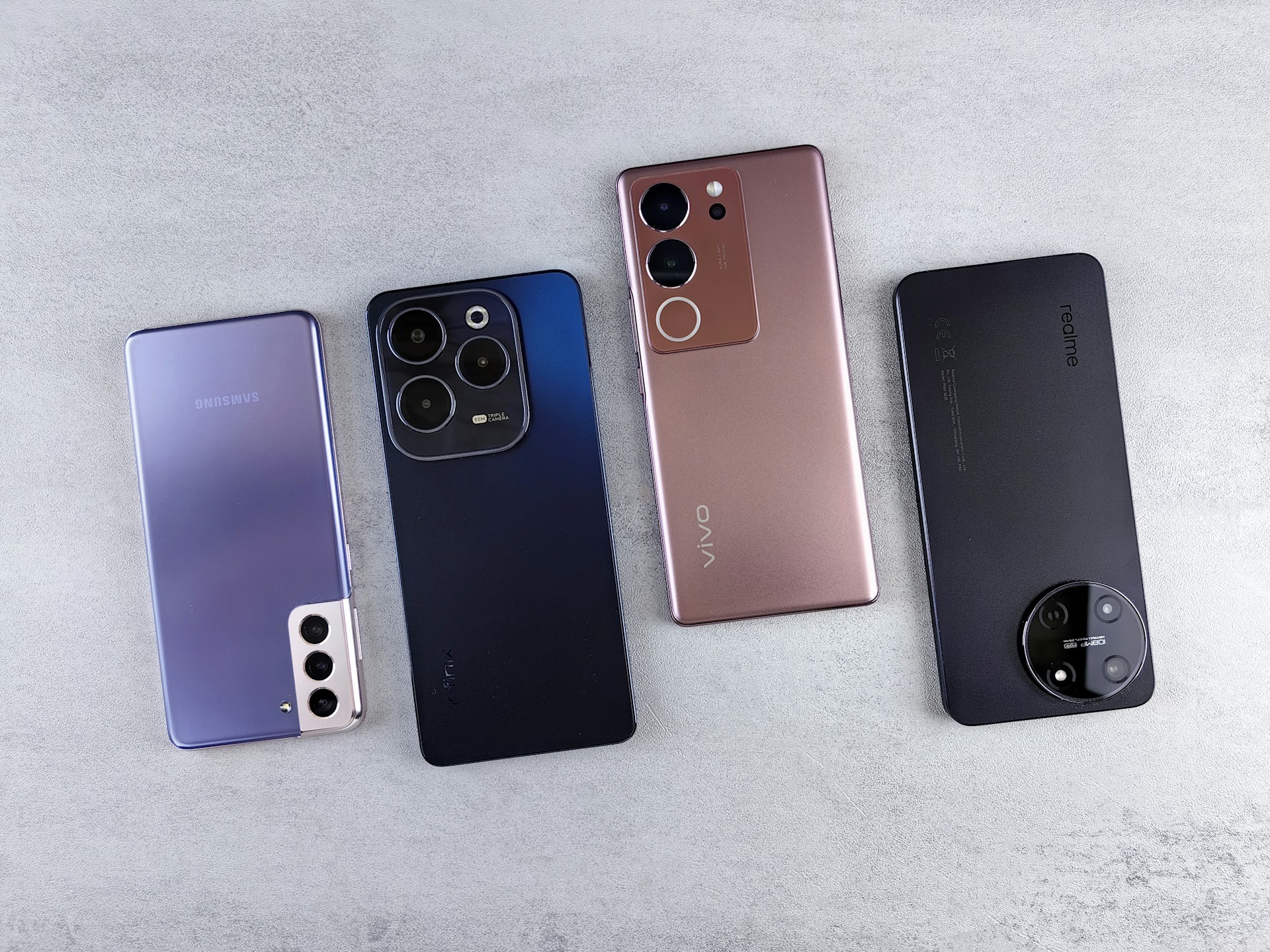 a group of four cell phones sitting next to each other