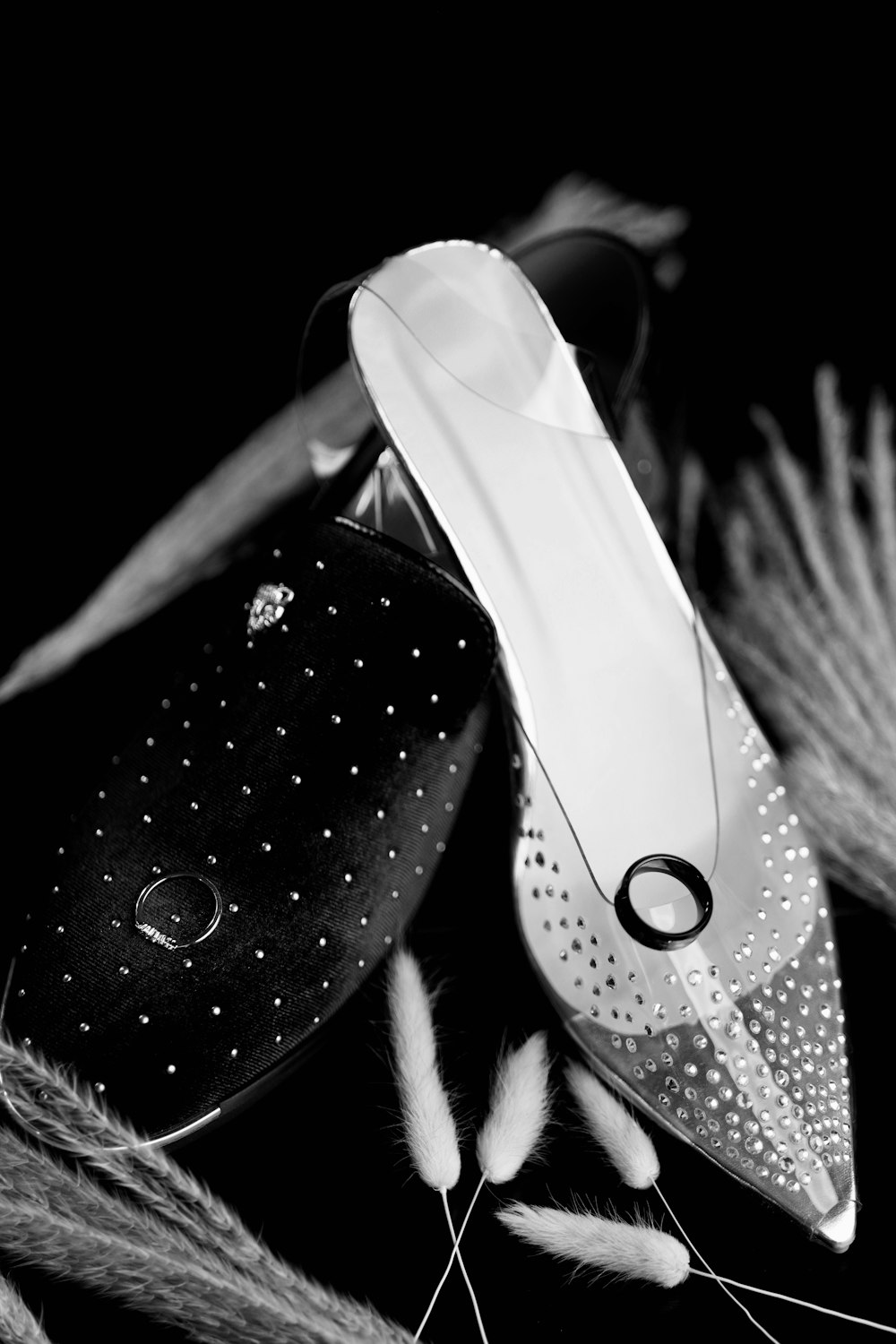 a pair of shoes sitting on top of a pile of feathers