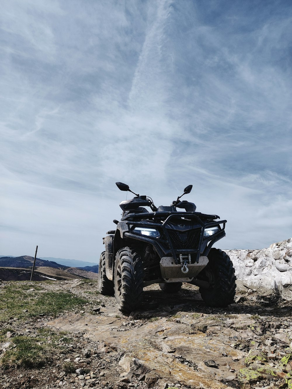 a four - wheeler is parked on a rocky trail