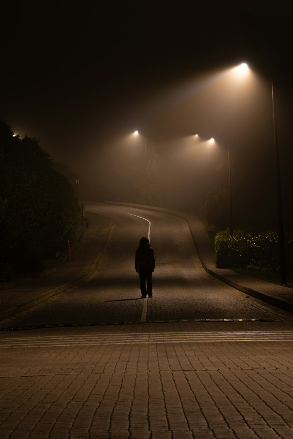 a person walking down a street at night