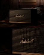 a couple of speakers sitting on top of a table