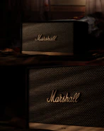 a couple of speakers sitting on top of a table