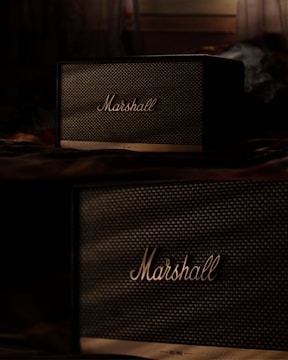 a couple of speakers sitting on top of a table