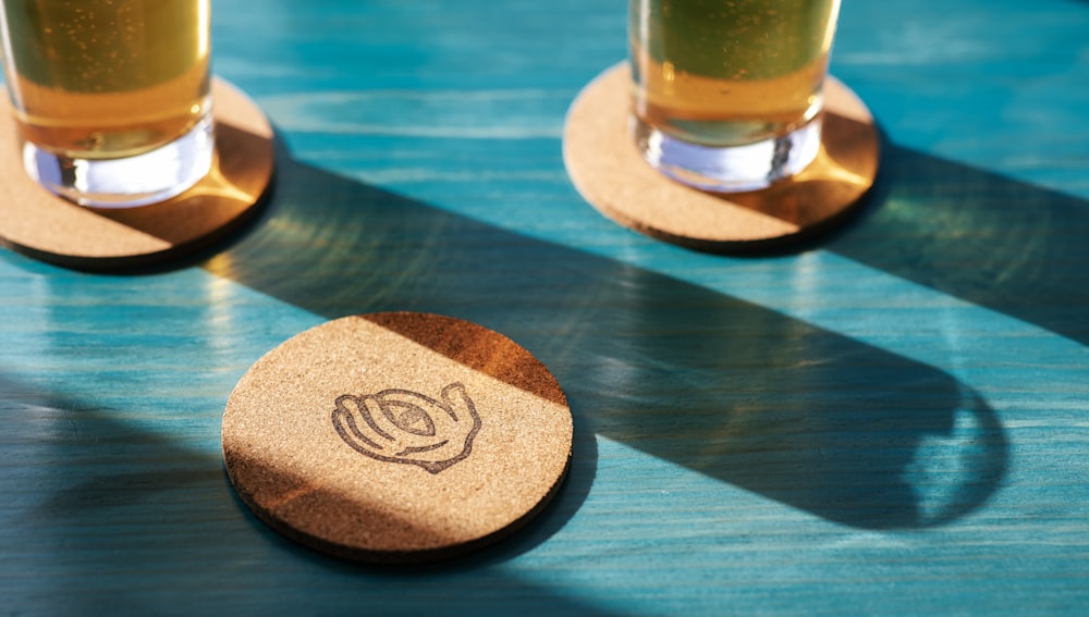 a couple of glasses of beer sitting on top of a table