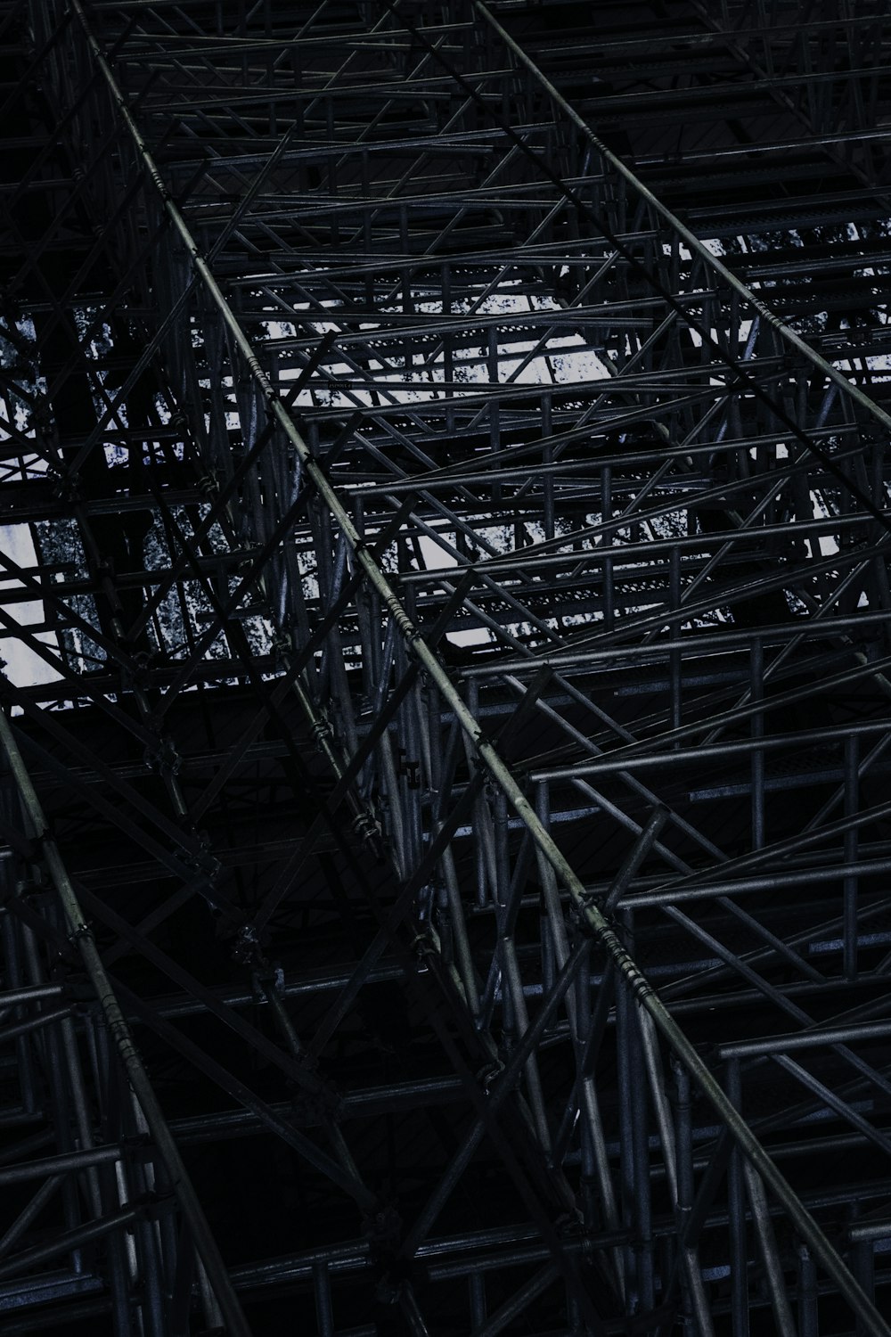 an airplane flying over a large metal structure