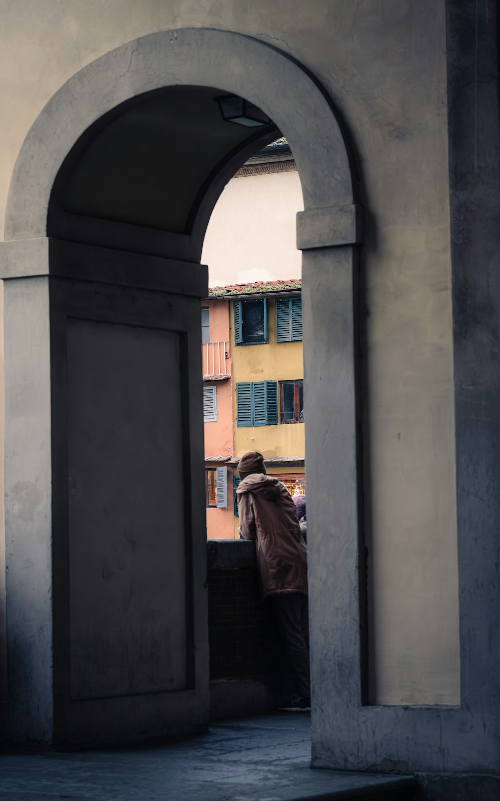 a man riding a horse through an archway