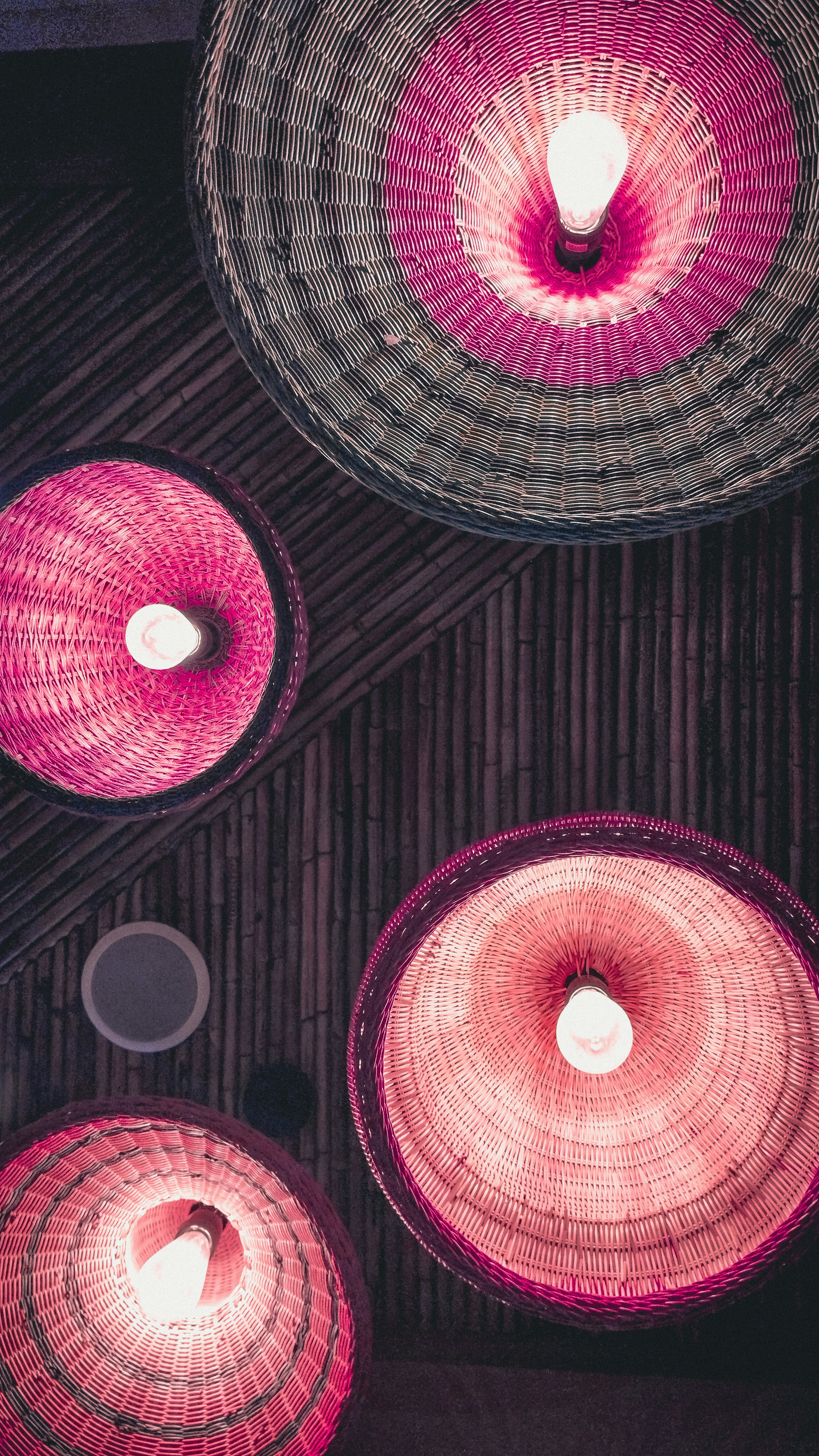 a group of wicker lamps hanging from the ceiling