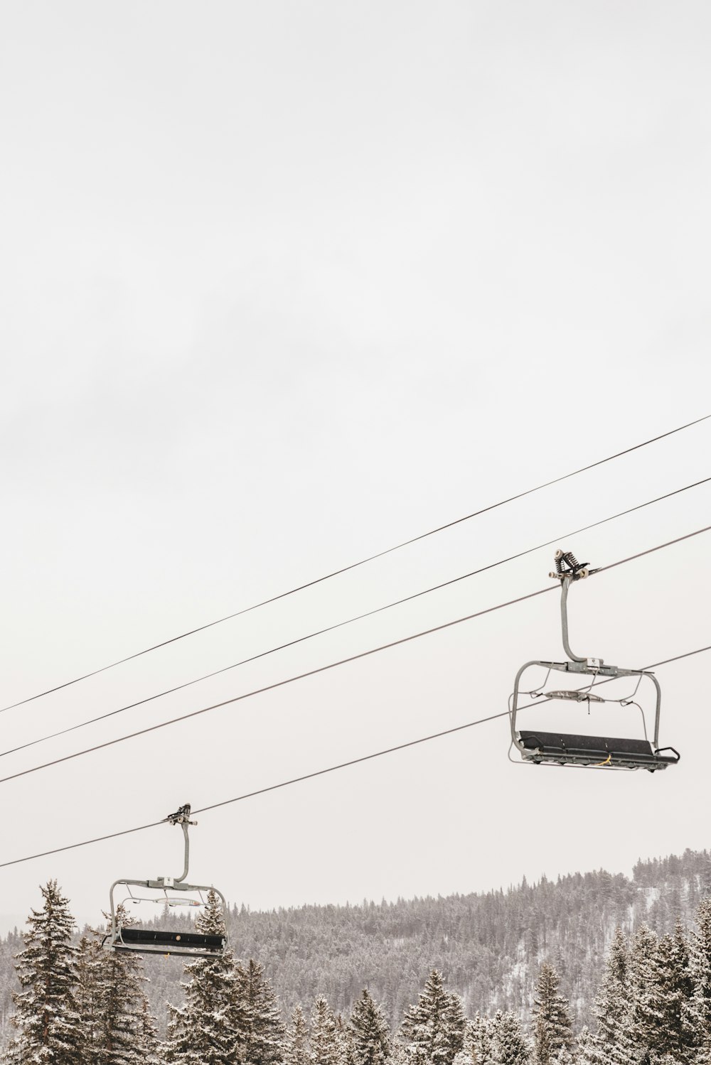 a ski lift going up a snowy mountain