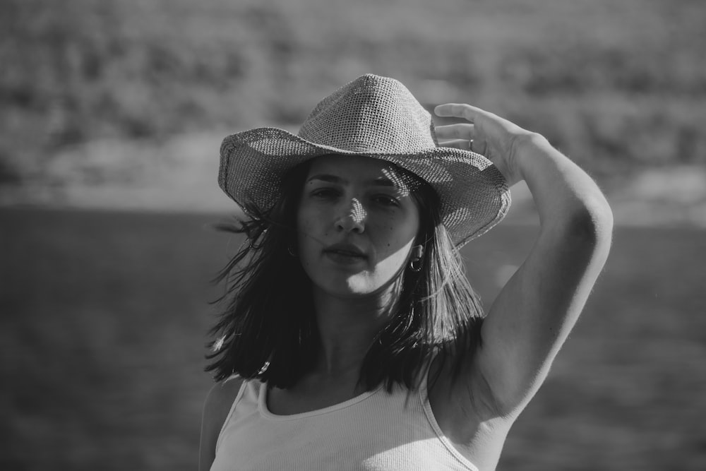 a woman in a hat poses for a picture