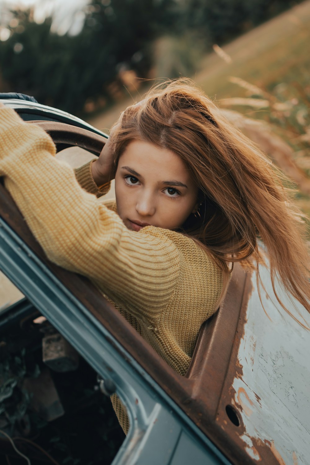 a woman leaning out the window of a car