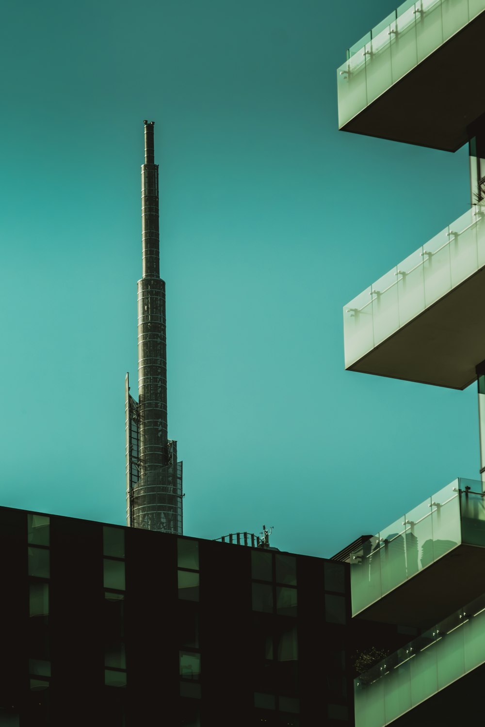 a tall building next to a tall building with balconies