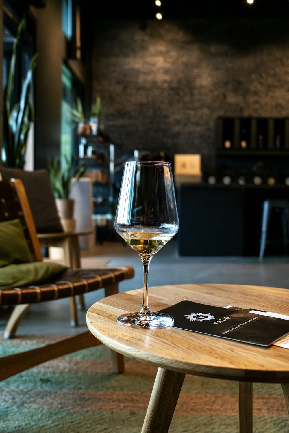 a glass of wine sitting on top of a wooden table