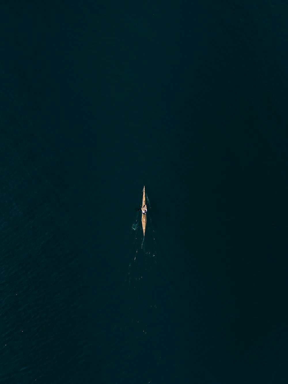 an aerial view of a boat in the water