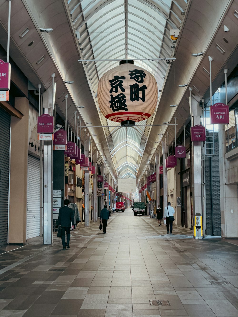 a long hallway with a sign hanging from the ceiling