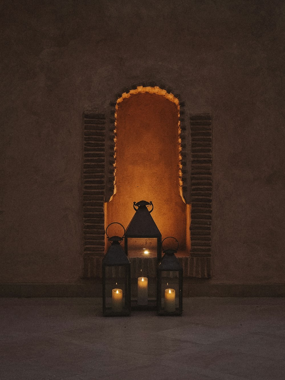 a couple of lanterns sitting in front of a window