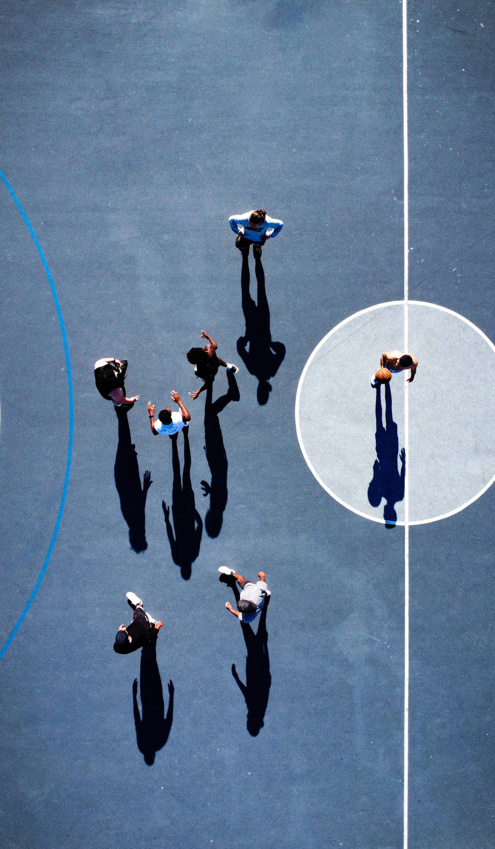 a group of people standing on top of a tennis court