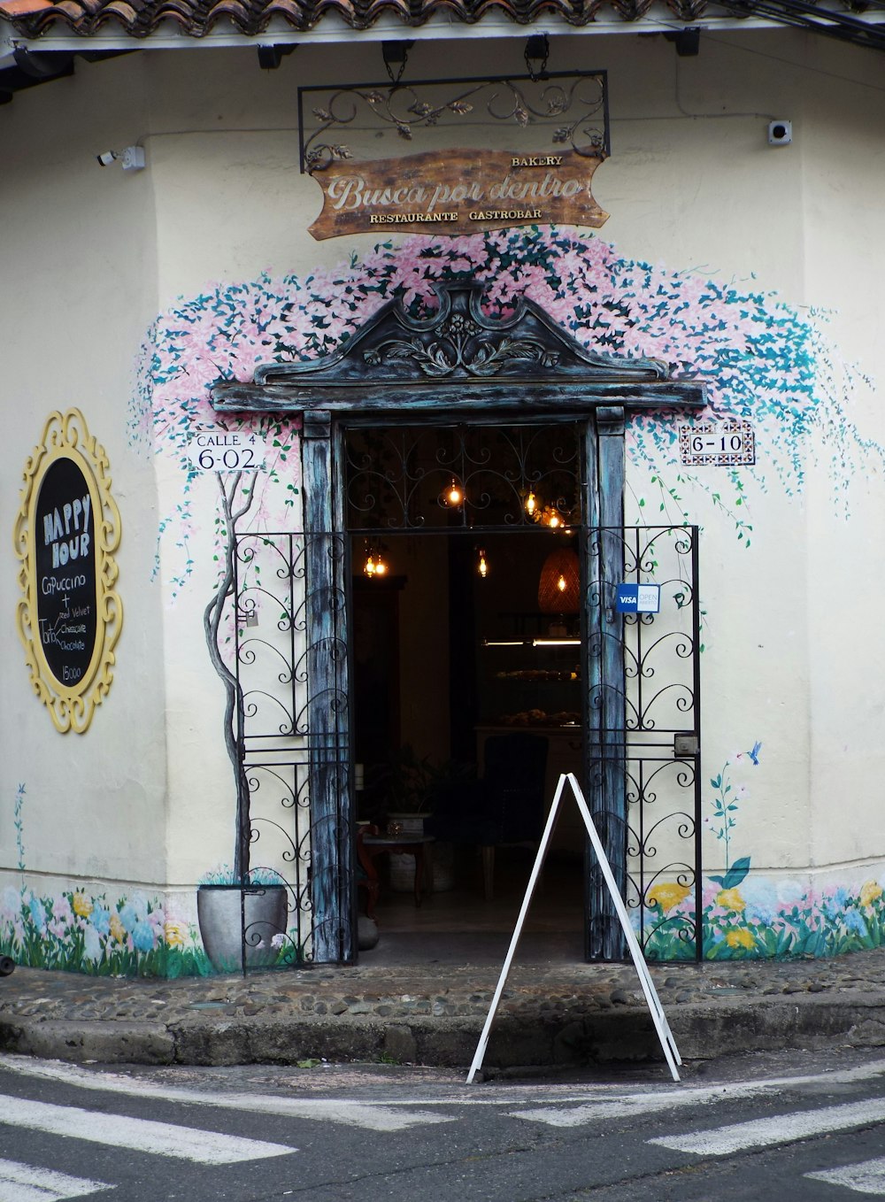 the entrance to a restaurant with a sign in front of it