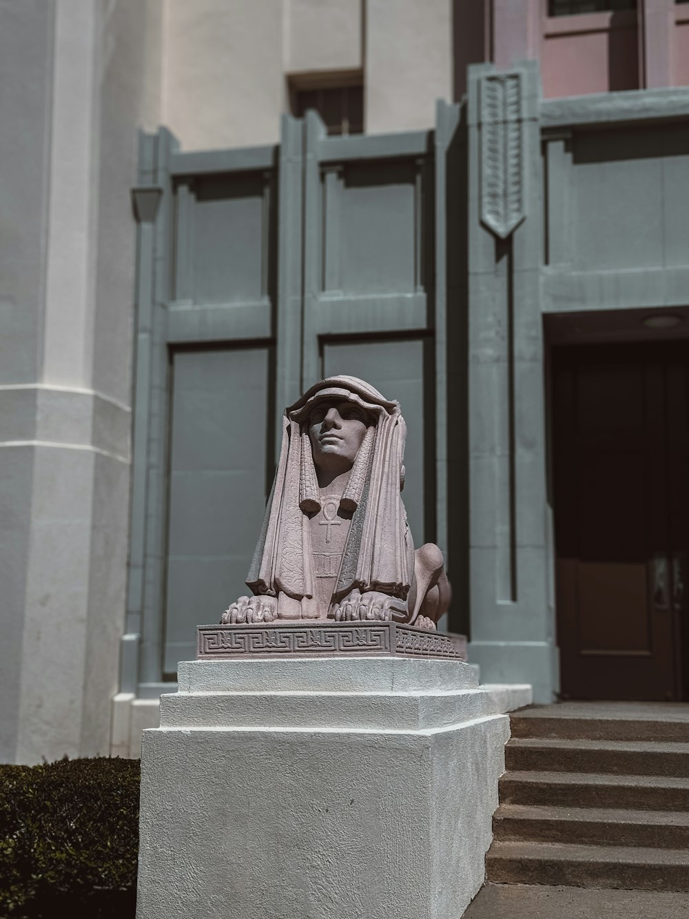 a statue of a woman in front of a building