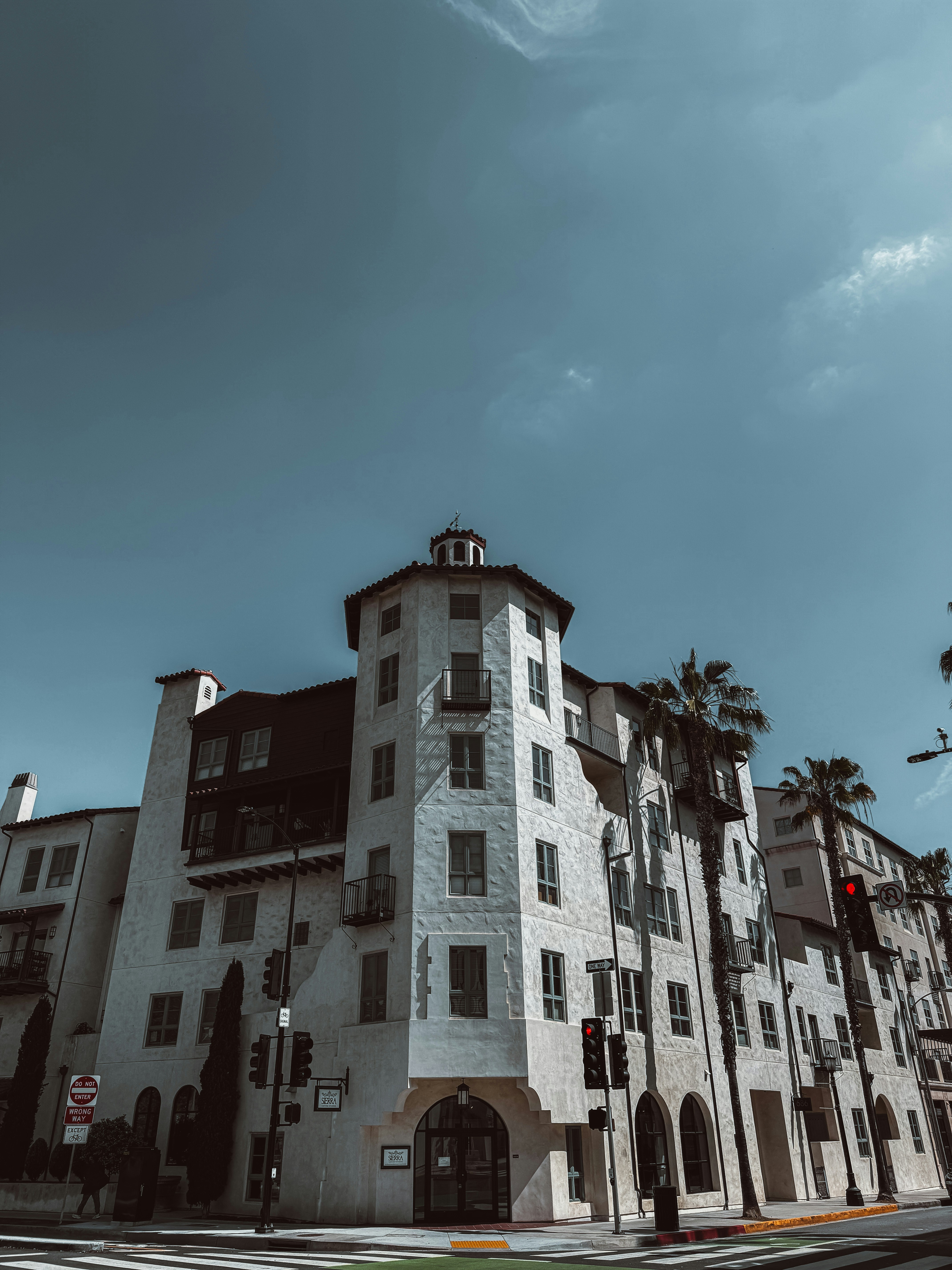 a tall white building sitting on the side of a road