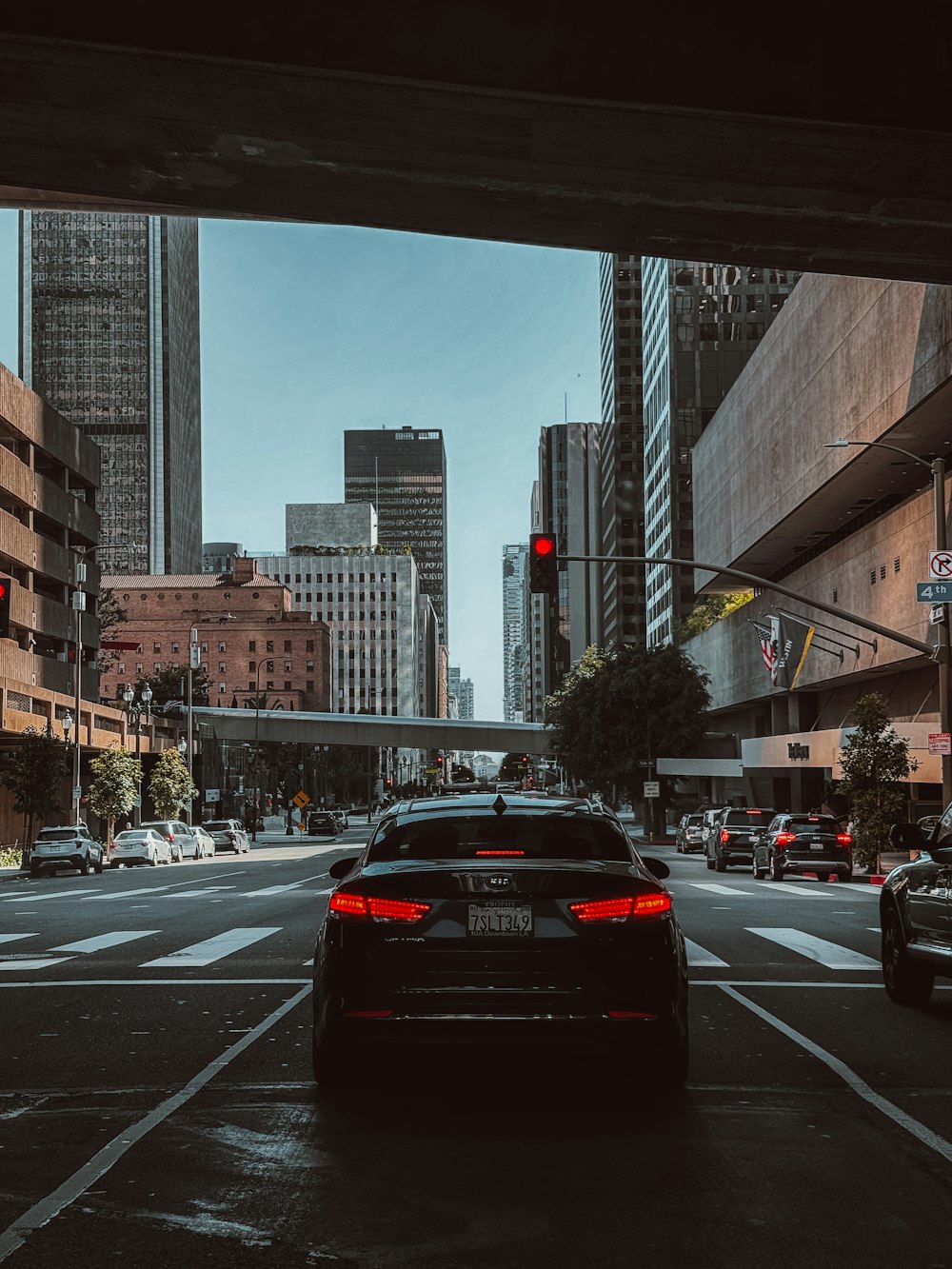 a car driving down a street next to tall buildings