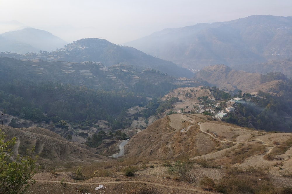 a view of a valley with mountains in the background