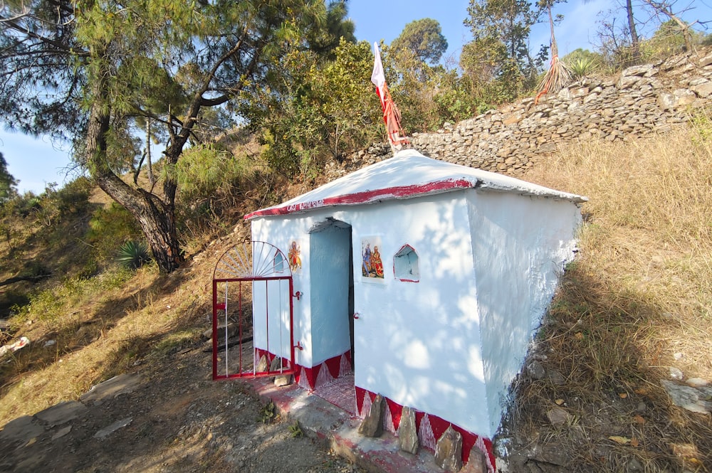 a small white building with a flag on top of it