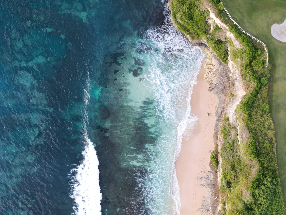 an aerial view of a golf course next to the ocean