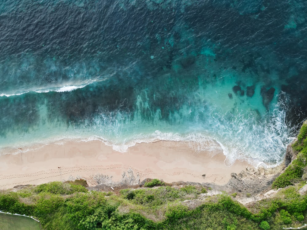 an aerial view of a sandy beach and ocean