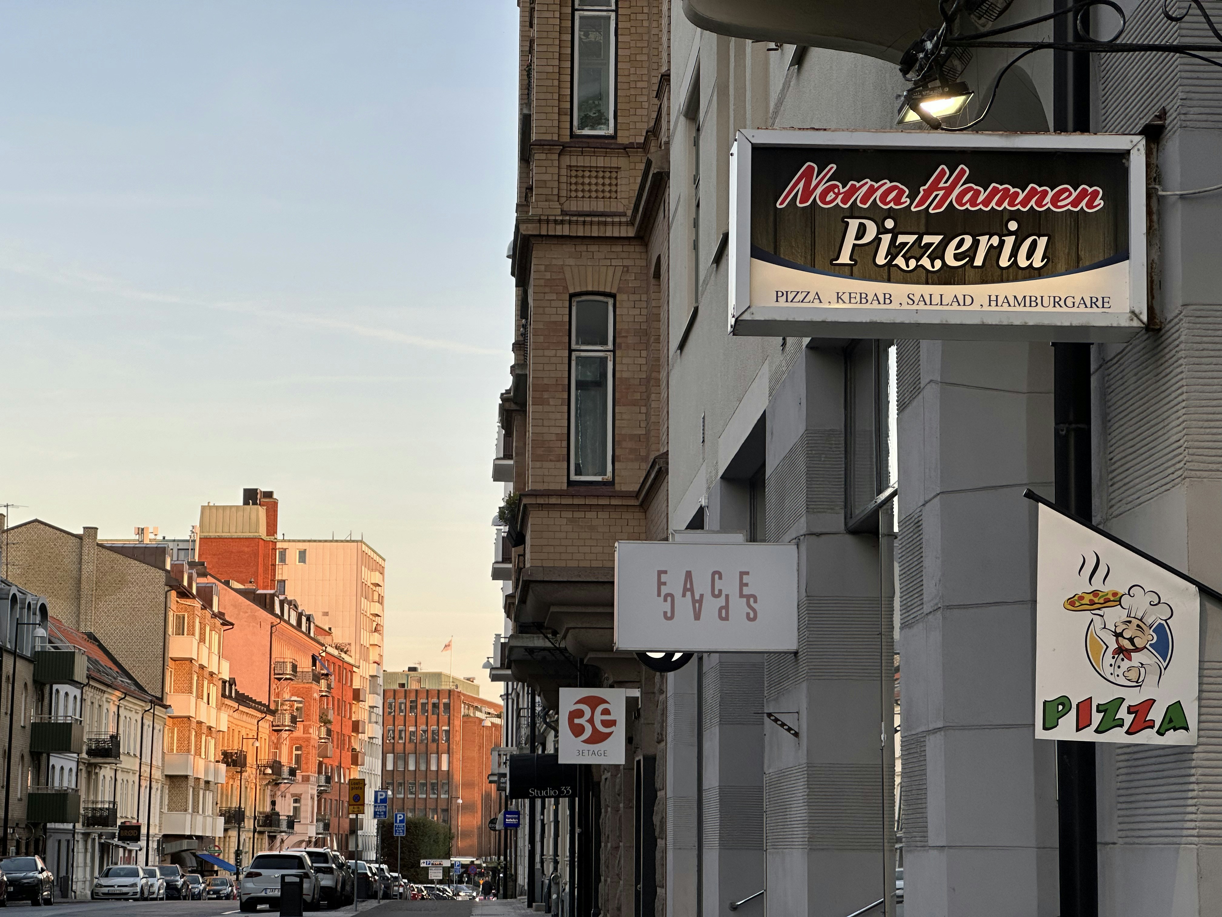 a sign for a pizzeria on the side of a building