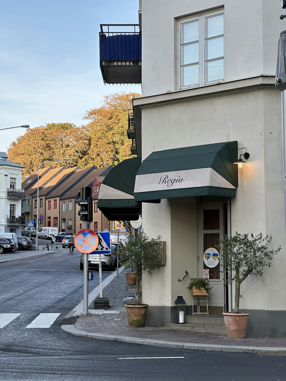 a building with a green awning next to a street