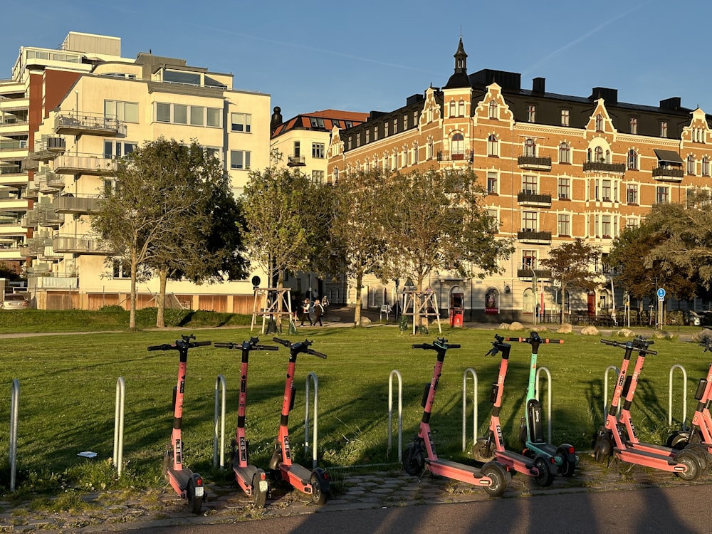 a row of scooters parked in front of a large building