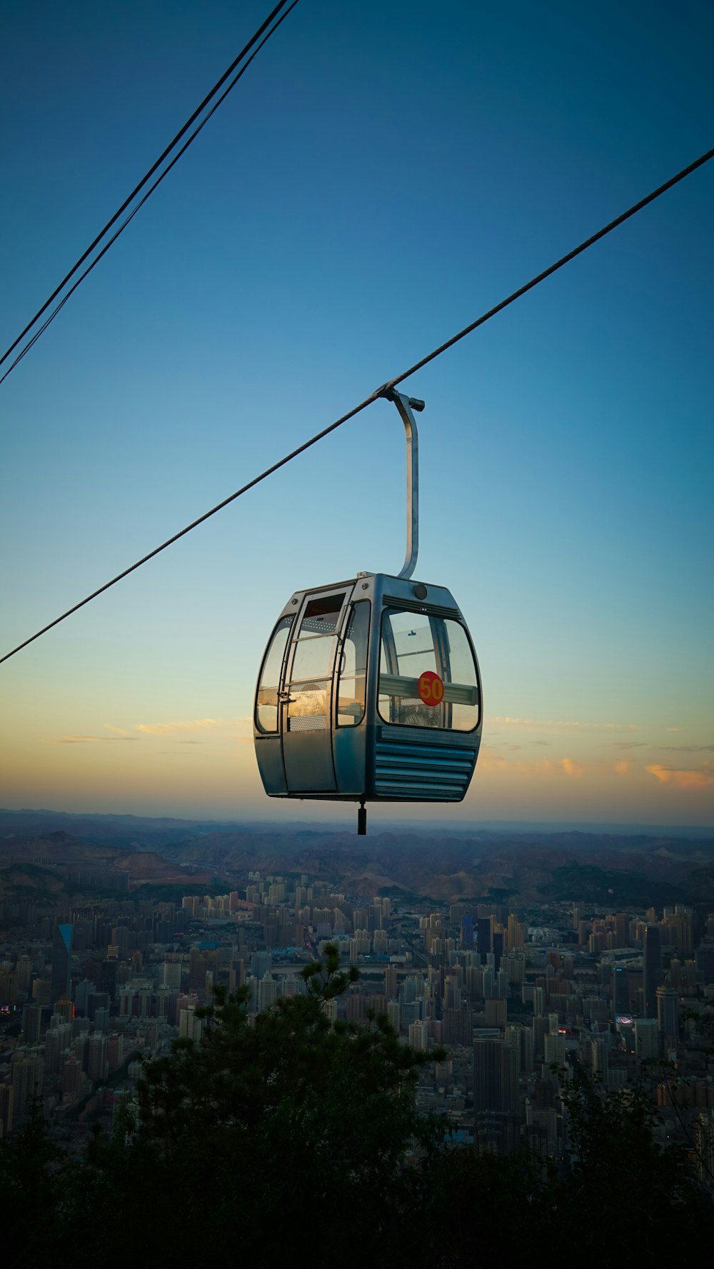 a gondola with a view of a city at sunset