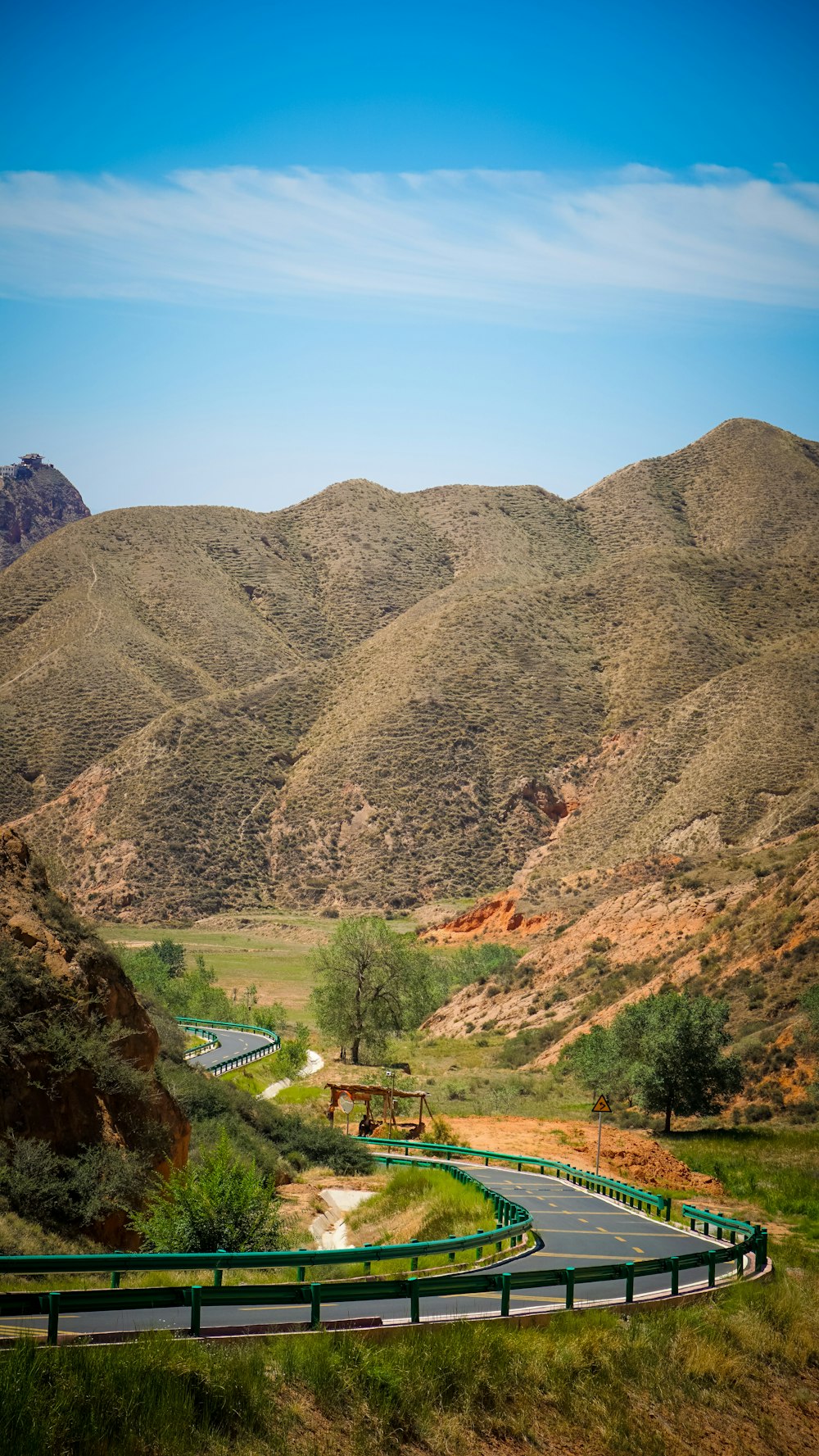 a winding road in the middle of a mountain range