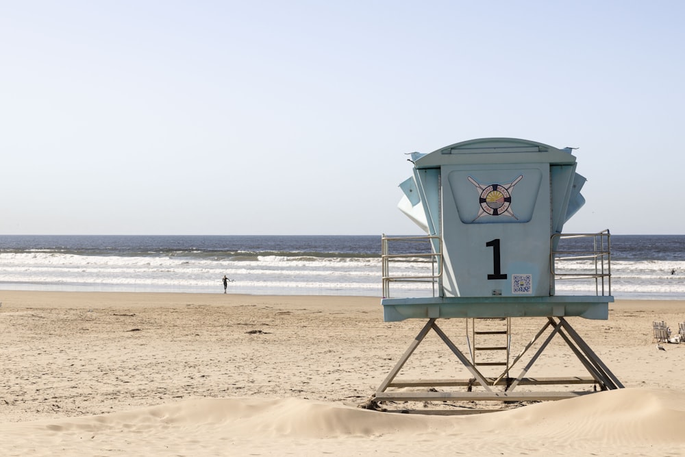 a lifeguard tower sitting on top of a sandy beach