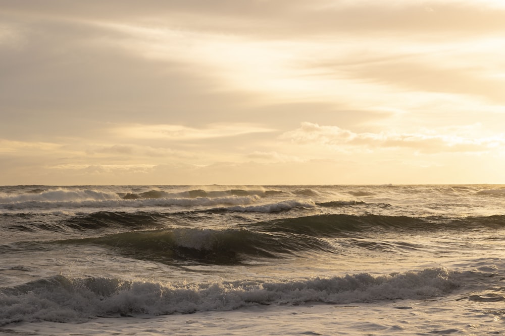 a person standing on a surfboard in the ocean