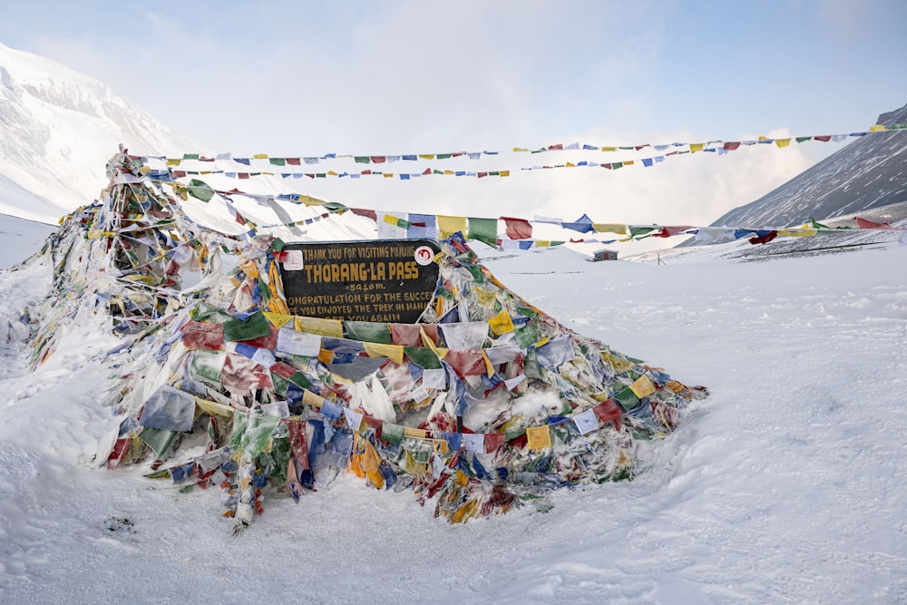 a mountain covered in snow with a sign in the middle of it