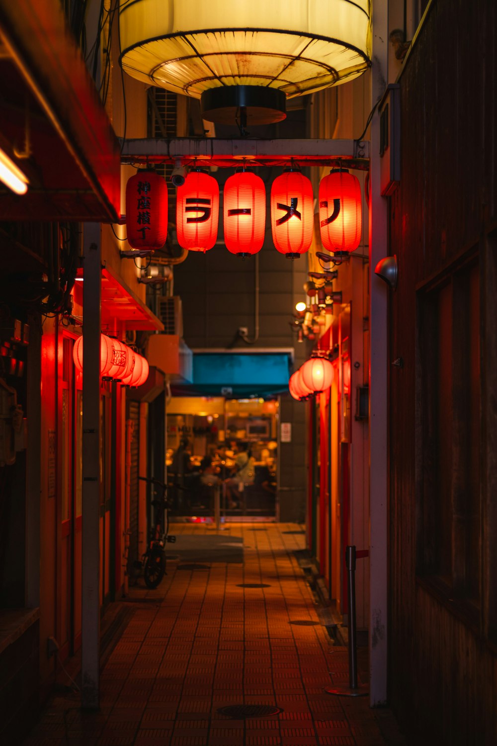 a long hallway with red lanterns hanging from the ceiling