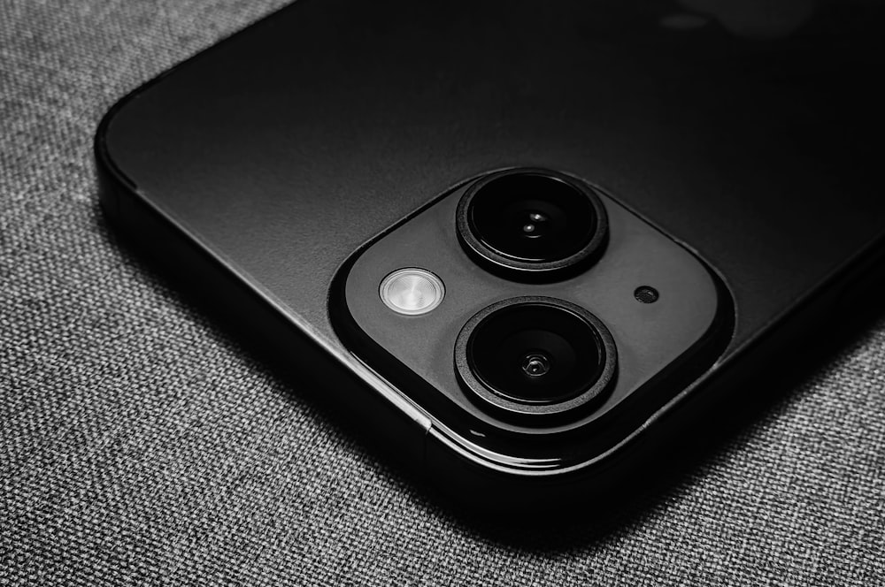 a close up of a cell phone with two cameras