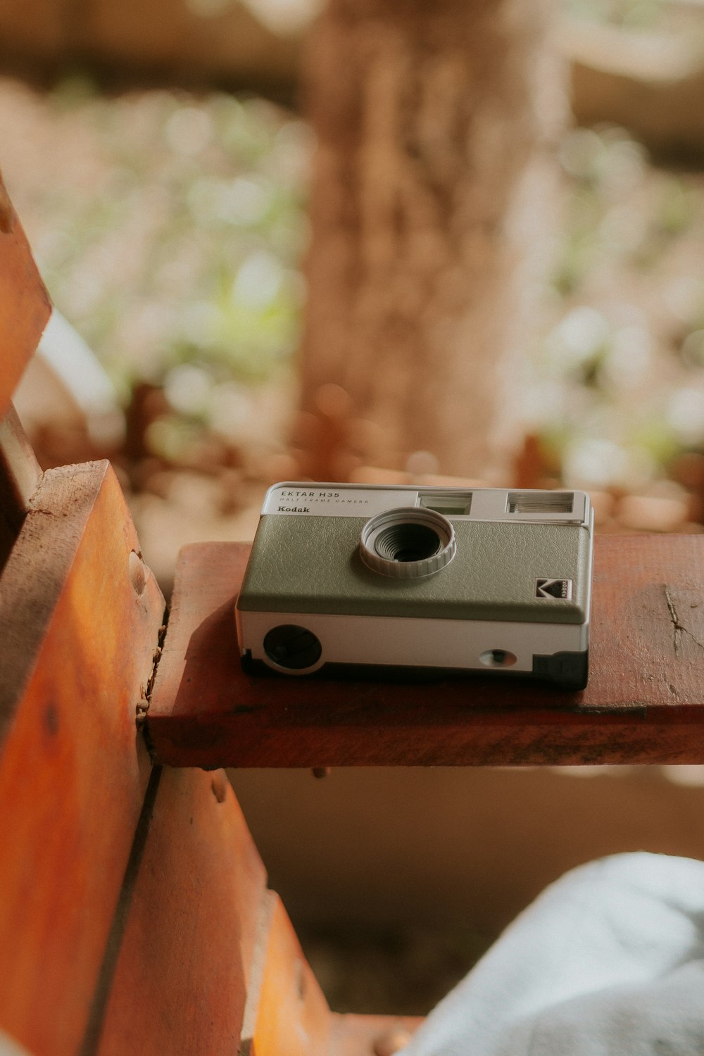 a camera sitting on top of a wooden bench