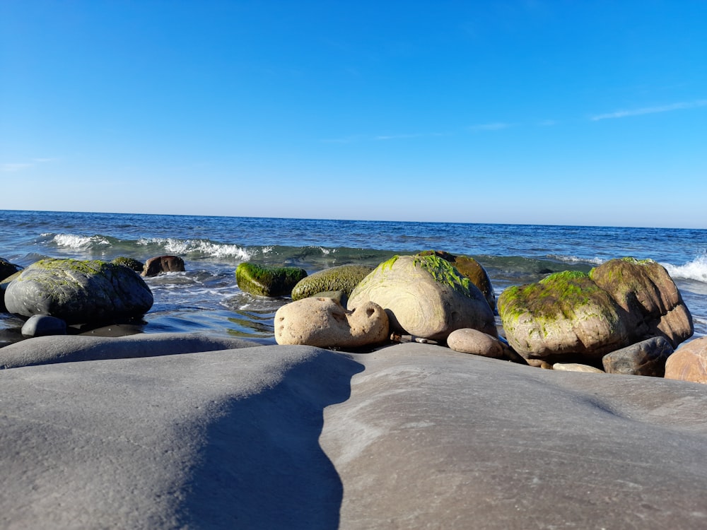 some rocks and water on a sunny day