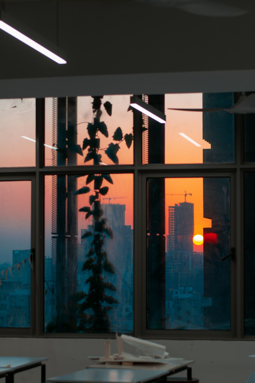 a window view of a city at sunset