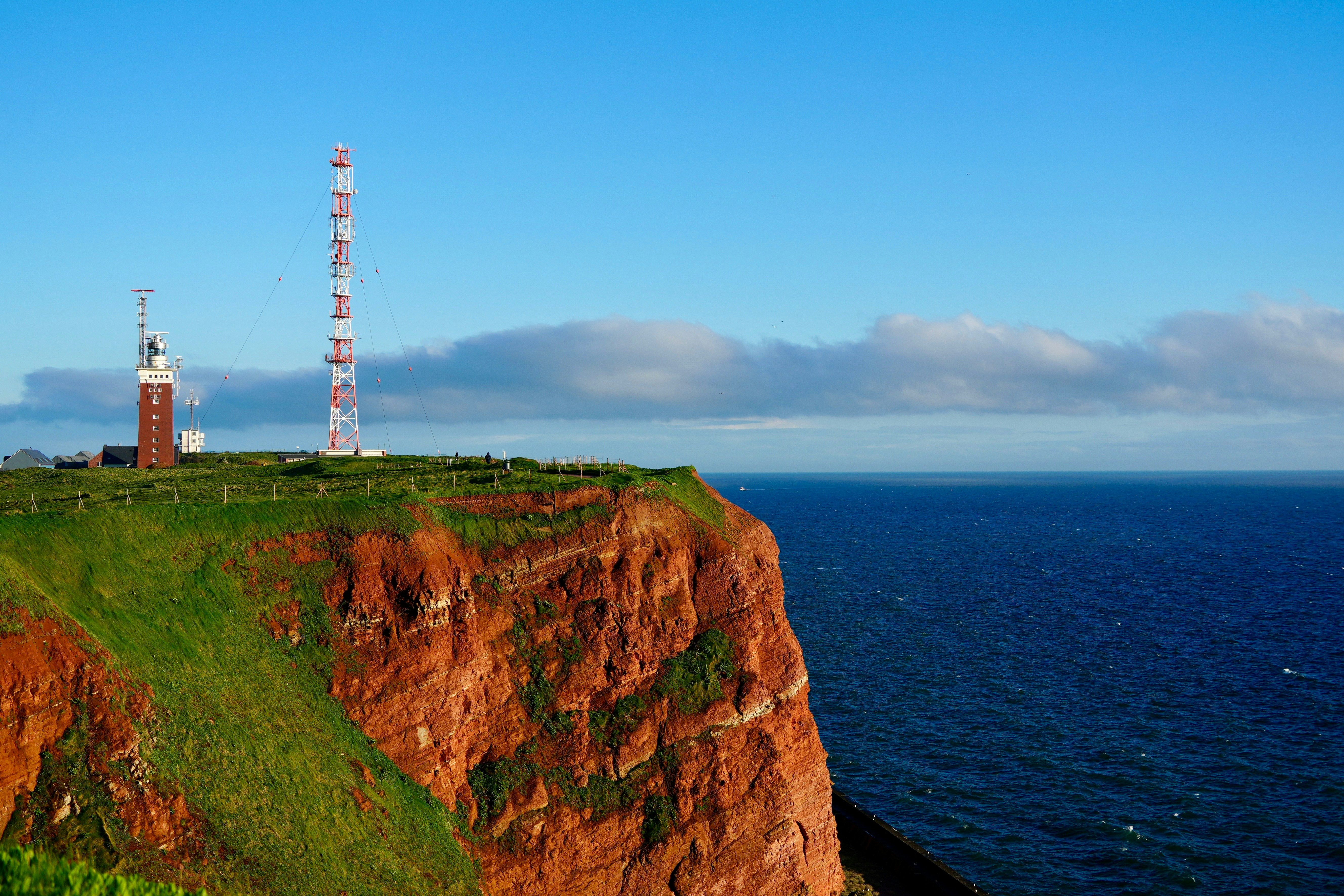 a tall tower on top of a cliff next to the ocean