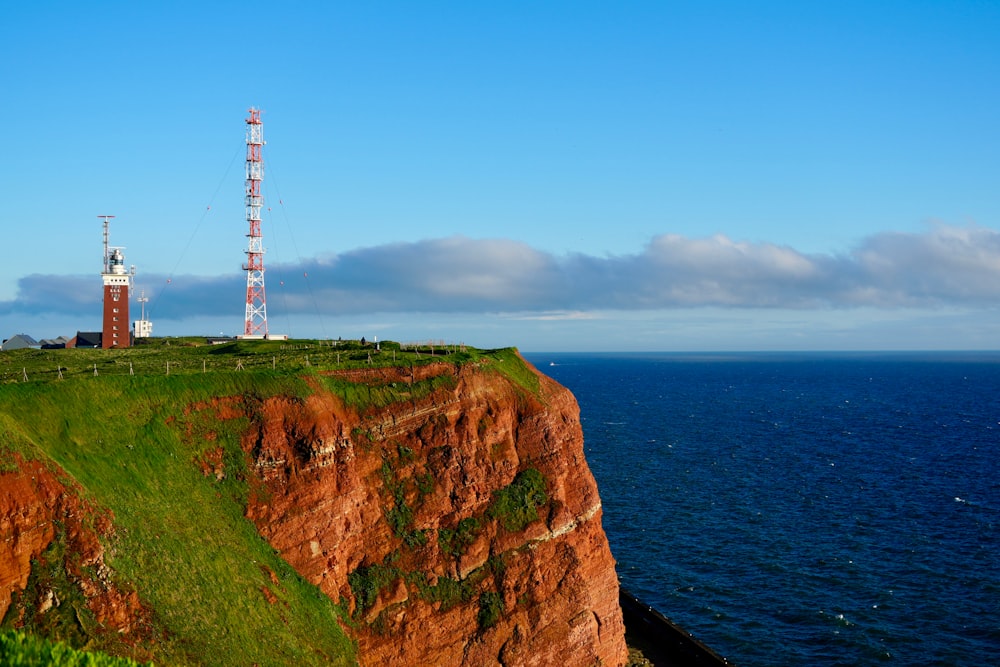 a tall tower on top of a cliff next to the ocean