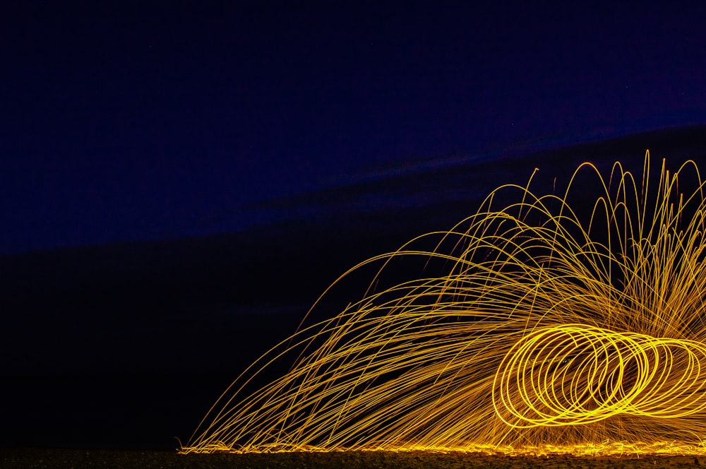 a long exposure of a firework at night