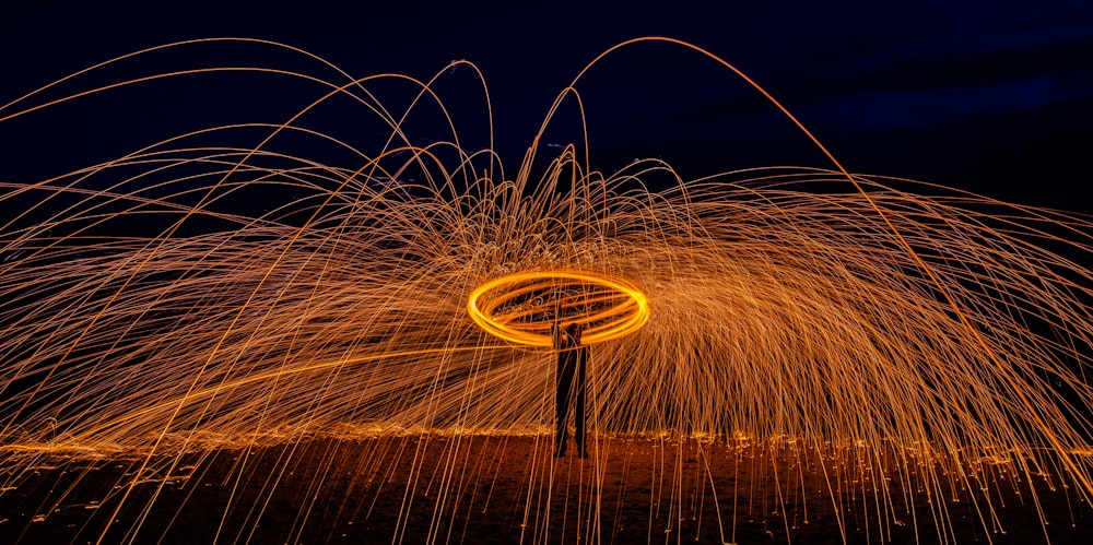 a man standing in front of a spinning steel wool