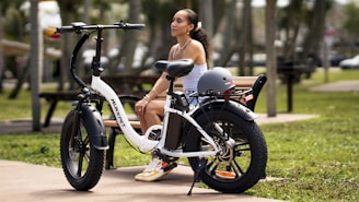 a woman sitting on a bench next to a bike
