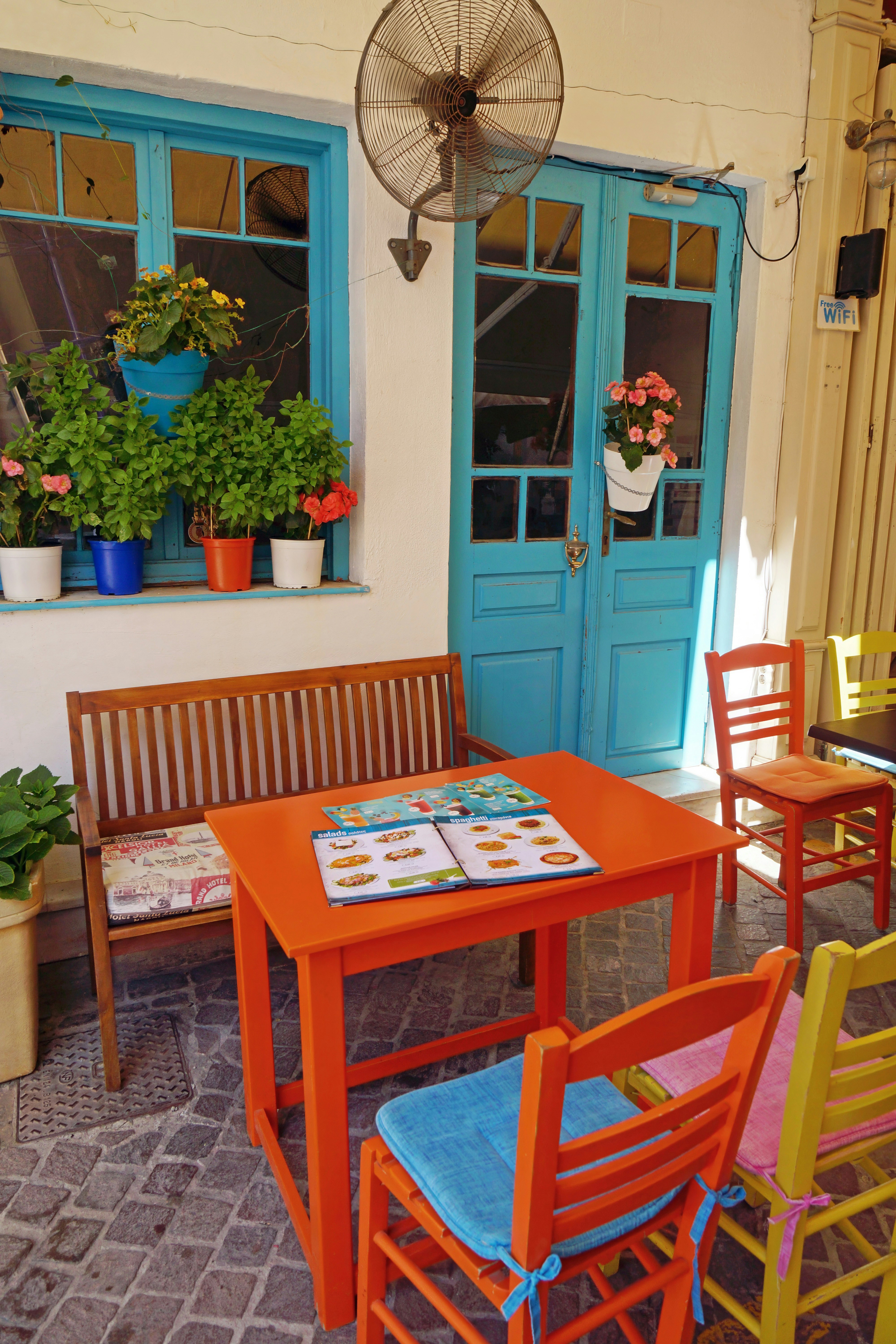 A patio with a table and chairs and potted plants
